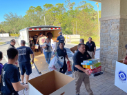 Members of Greenacres and Estero Fire Rescue unloading the toys from the trailer.