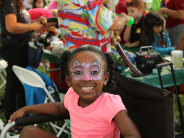Girl smiling after face painting 