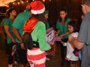 Elf handing out toys to children