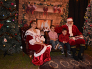 Children taking a photo with Santa and Mrs Claus