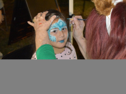 Girl having her face painted