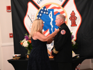 Chief Konz wife, Jennifer, pinning his new badge following the oath.