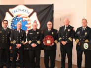Chief Fuller holding a plaque he was presented alongside the Palm Beach County Chiefs Association.