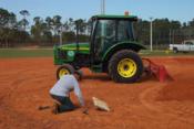 tractor laying dirt on a baseball field