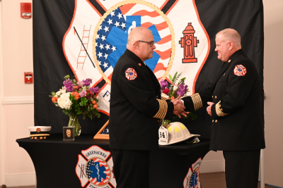 Chief Fuller Presenting Chief Konz with the Fire Chief Badge